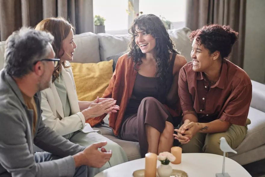A chosen family talking together on a couch.